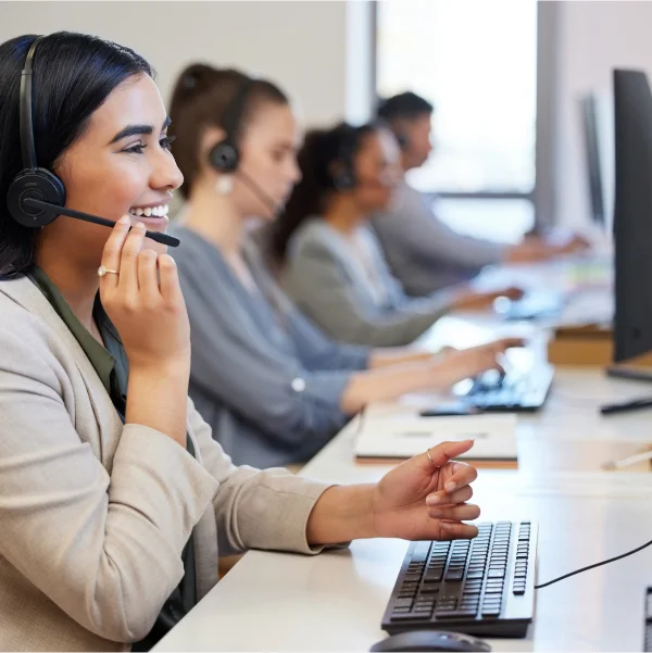 A woman in a headset providing remote customer service in a call center environment.